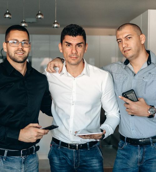 Group of diverse professionals looking relaxed and happy in a bright office.